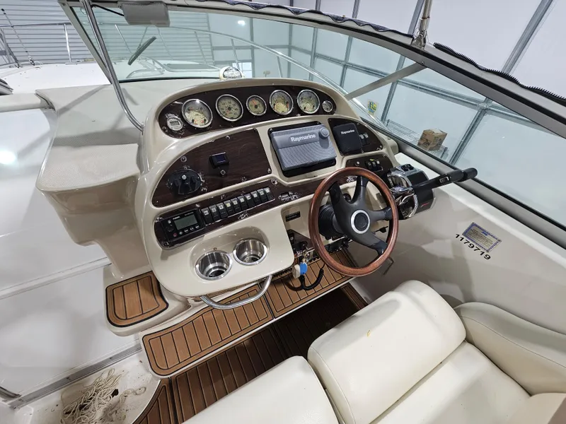 Slide: The Image of 2005 Chaparral Signature 330 boat dashboard with gauges, steering wheel, and navigation system. - 6