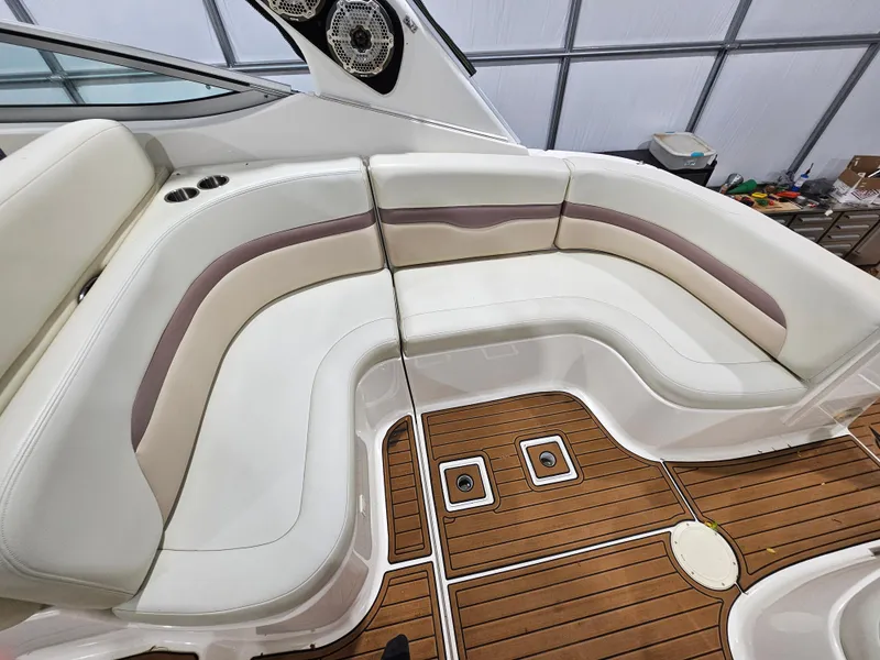 Slide: The Image of 2005 Chaparral Signature 330 boat interior with white and beige seating, wooden deck. - 8