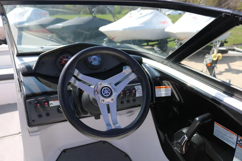 Slide: The Image of 2018 Yamaha Boats AR 195 steering wheel and dashboard, showcasing controls and gauges. - 10
