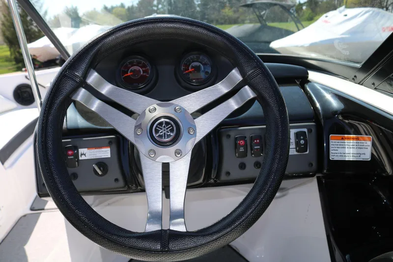 Slide: The Image of Steering wheel of 2018 Yamaha Boats AR 195, featuring dashboard controls and gauges. - 11