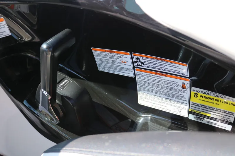 Slide: The Image of Close-up of 2018 Yamaha AR 195 boat controls and safety warnings. - 12