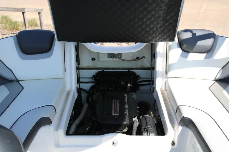 Slide: The Image of 2018 Yamaha Boats AR 195 engine compartment with open hatch, showcasing interior components. - 14
