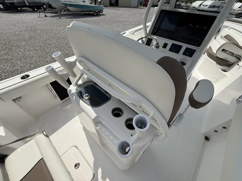Slide: The Image of 2025 Tidewater 232 CC Adventure boat interior with helm, seating, and cup holders. - 11