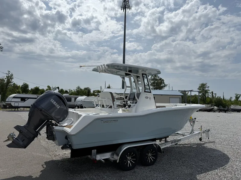 Slide: The Image of 2025 Tidewater 232 CC Adventure boat with Seakeeper Ride on trailer, parked outdoors. - 3