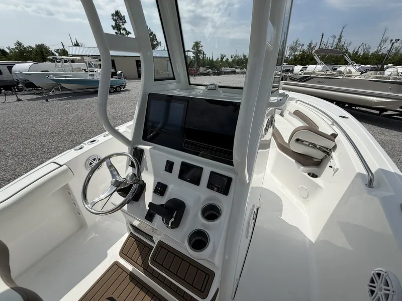Slide: The Image of 2025 Tidewater 232 CC Adventure boat interior with Seakeeper Ride, featuring modern helm controls. - 9