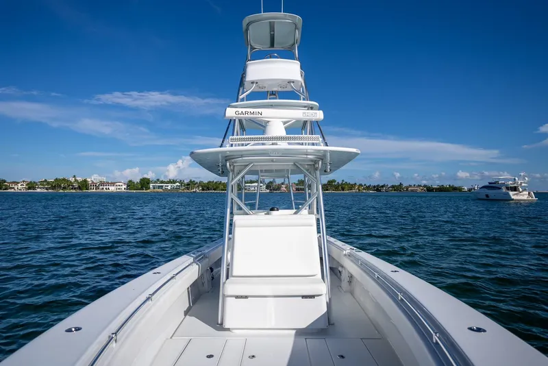 Slide: The Image of 2018 Contender 39 ST boat on open water under clear blue sky. - 16