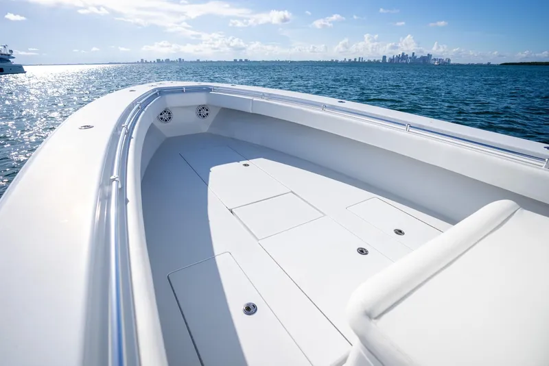 Slide: The Image of 2018 Contender 39 ST boat on calm ocean with city skyline in background. - 17