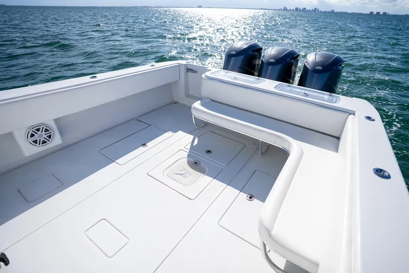 Slide: The Image of 2018 Contender 39 ST boat deck with triple outboard motors on open water. - 22