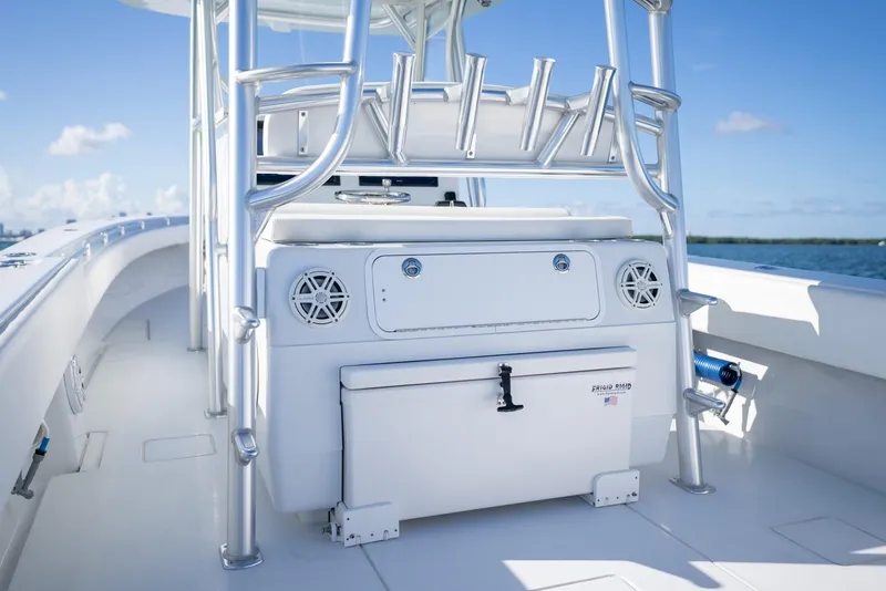 Slide: The Image of 2018 Contender 39 ST boat interior with rod holders and storage, under clear blue sky. - 23