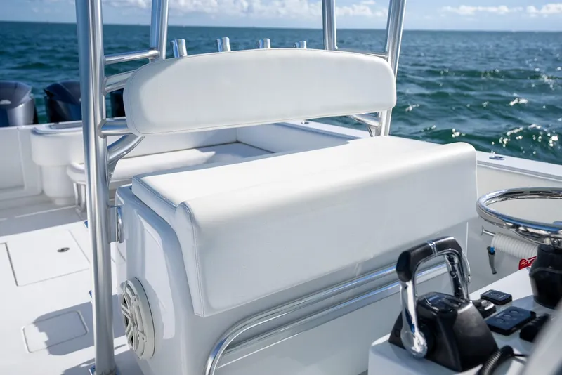 Slide: The Image of 2018 Contender 39 ST boat interior with white seating and ocean backdrop. - 24
