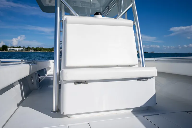 Slide: The Image of 2018 Contender 39 ST boat interior with white seating, ocean view, and clear blue sky. - 25