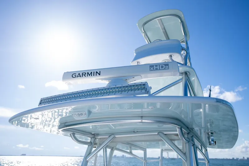 Slide: The Image of 2018 Contender 39 ST boat with Garmin xHD2 radar against a bright blue sky. - 27