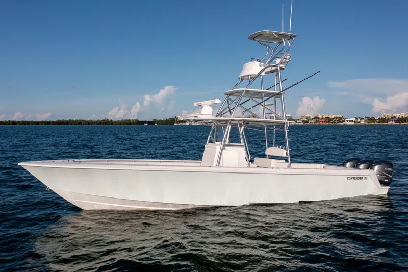 Slide: The Image of 2018 Contender 39 ST boat on calm water under clear blue sky. - 3