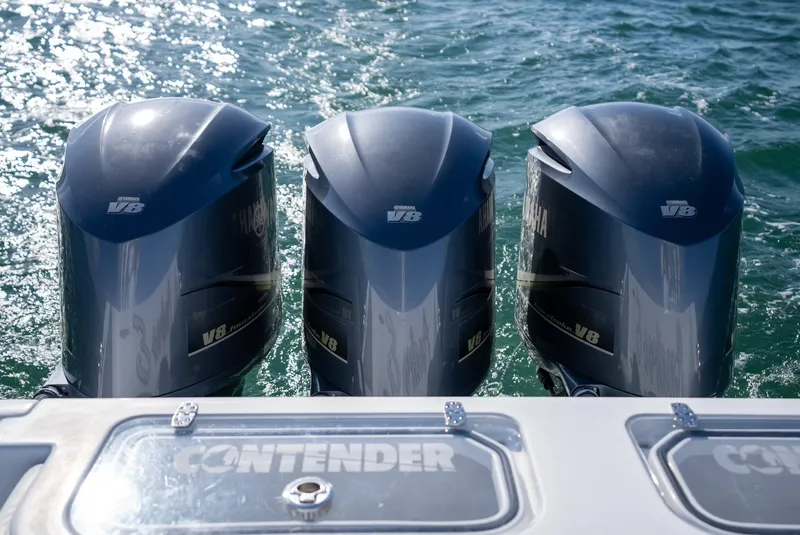 Slide: The Image of Three powerful V8 outboard engines on a 2018 Contender 39 ST boat. - 30