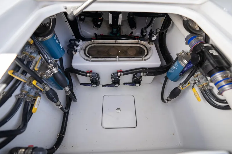 Slide: The Image of Engine compartment of a 2018 Contender 39 ST boat, showcasing detailed wiring and components. - 32