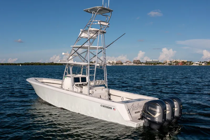 Slide: The Image of 2018 Contender 39 ST boat with triple Yamaha engines on open water. - 4