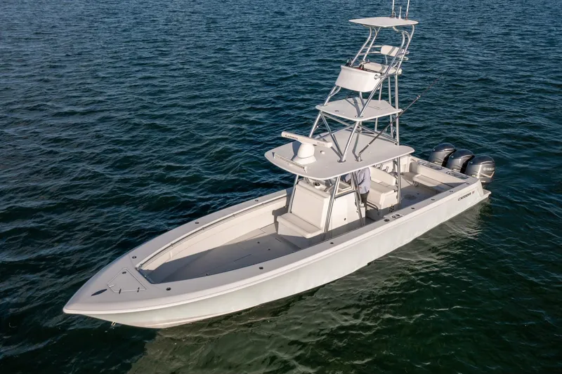 Slide: The Image of 2018 Contender 39 ST boat on open water, featuring triple outboard engines. - 5