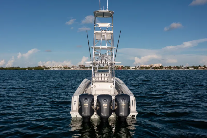 Slide: The Image of 2018 Contender 39 ST boat with triple Yamaha engines on open water. - 7