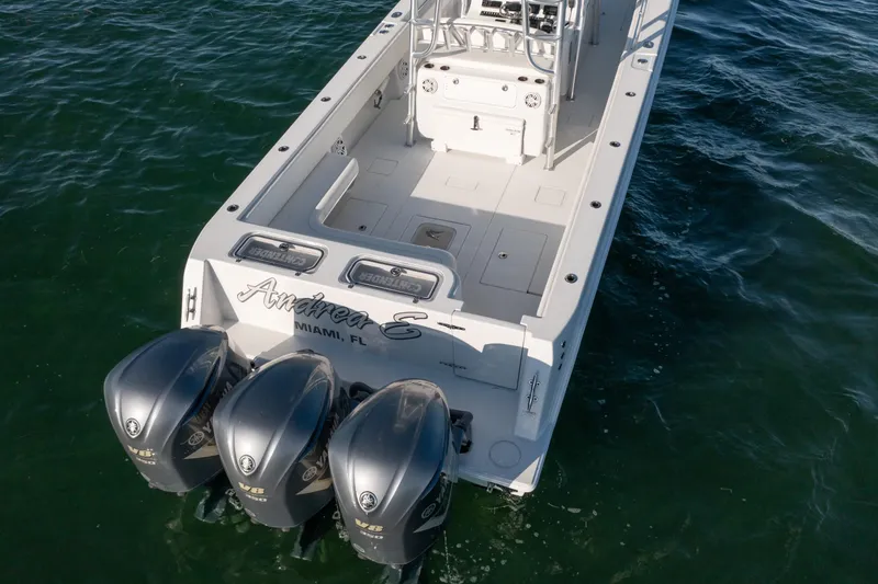 Slide: The Image of 2018 Contender 39 ST boat with triple outboard engines on the water. - 8