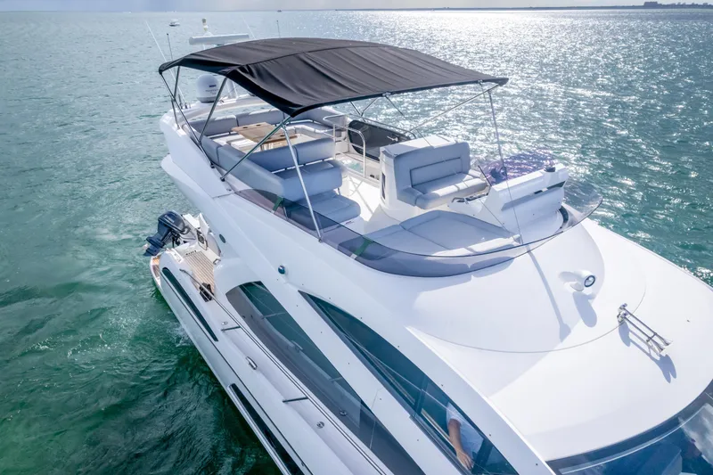 Slide: The Image of 2016 Sunseeker Manhattan 55 yacht cruising on open water, featuring sleek design and spacious deck. - 10