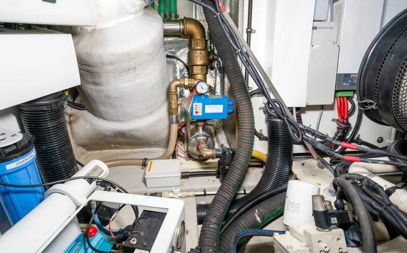 Slide: The Image of Engine room of 2016 Sunseeker Manhattan 55 yacht, showcasing mechanical components and wiring. - 100