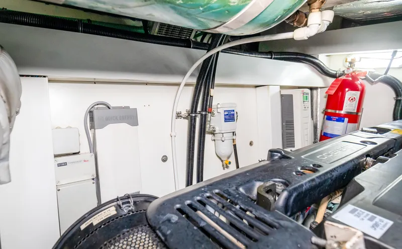 Slide: The Image of Engine room of 2016 Sunseeker Manhattan 55 yacht with visible machinery and fire extinguisher. - 103