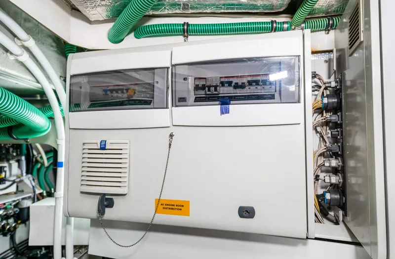 Slide: The Image of Electrical panel inside 2016 Sunseeker Manhattan 55 yacht, featuring wiring and circuit breakers. - 104