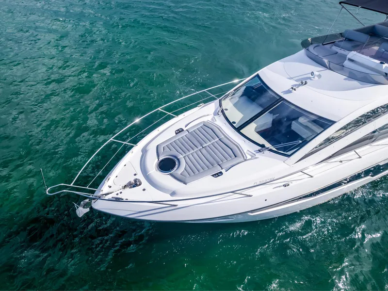 Slide: The Image of Sunseeker Manhattan 55 yacht cruising on clear turquoise water, aerial view, 2016 model. - 15