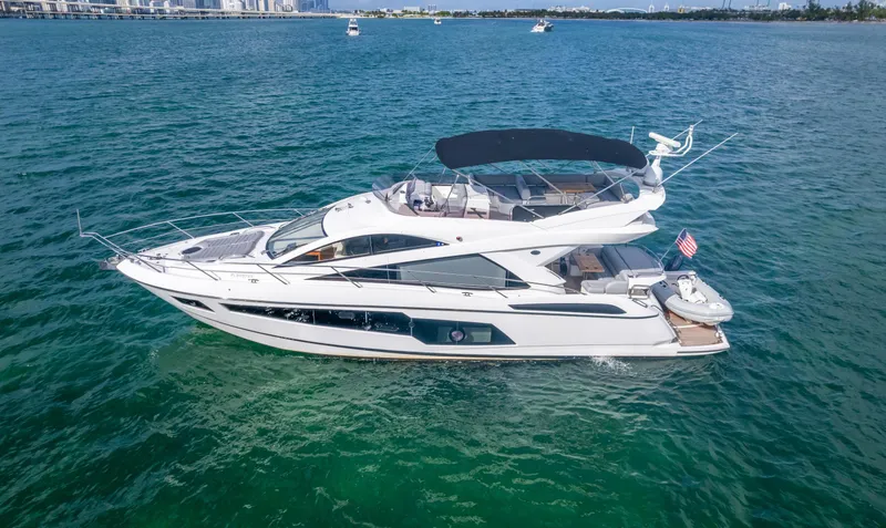 Slide: The Image of 2016 Sunseeker Manhattan 55 yacht cruising on clear blue water. - 3