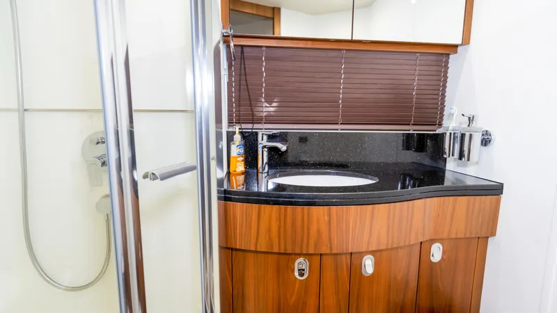 Slide: The Image of Luxurious bathroom in 2016 Sunseeker Manhattan 55 yacht with modern fixtures and wood accents. - 30