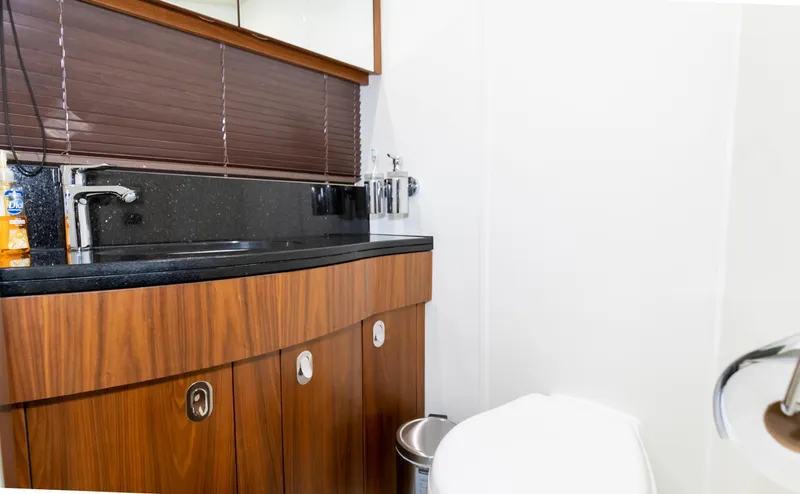 Slide: The Image of Luxurious bathroom in 2016 Sunseeker Manhattan 55 yacht with wooden cabinetry and modern fixtures. - 31