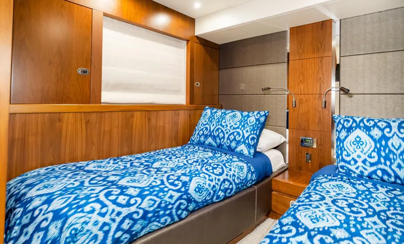 Slide: The Image of Luxurious twin cabin in 2016 Sunseeker Manhattan 55 yacht with blue patterned bedding. - 32