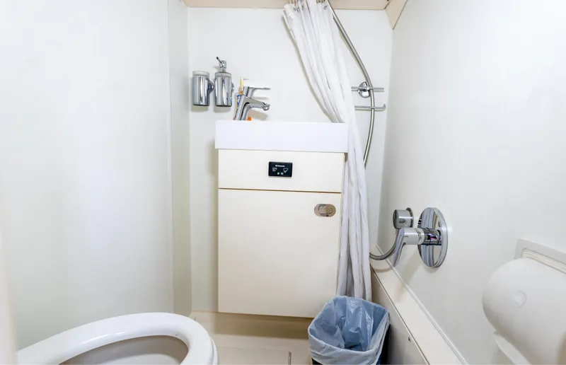 Slide: The Image of Bathroom interior of 2016 Sunseeker Manhattan 55 yacht, featuring sink, shower, and toilet. - 38