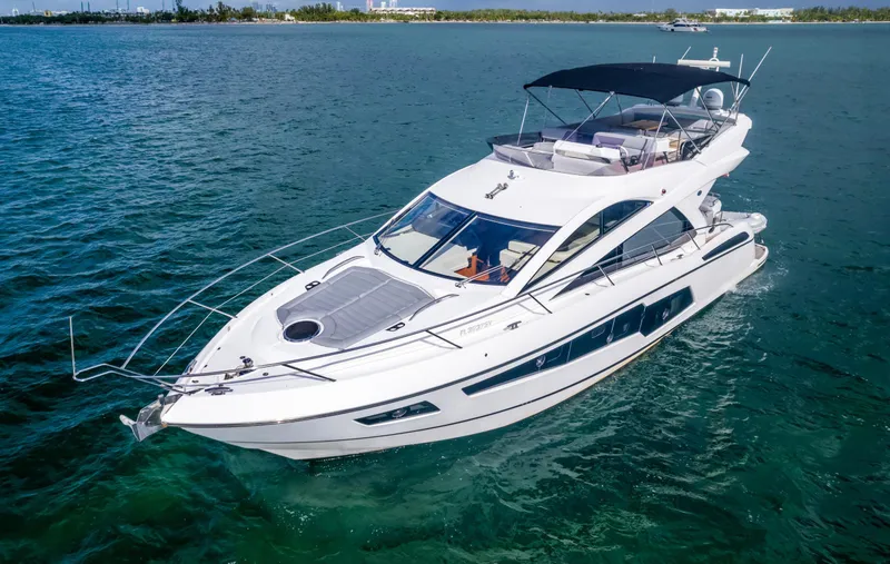 Slide: The Image of 2016 Sunseeker Manhattan 55 yacht cruising on open water. - 4