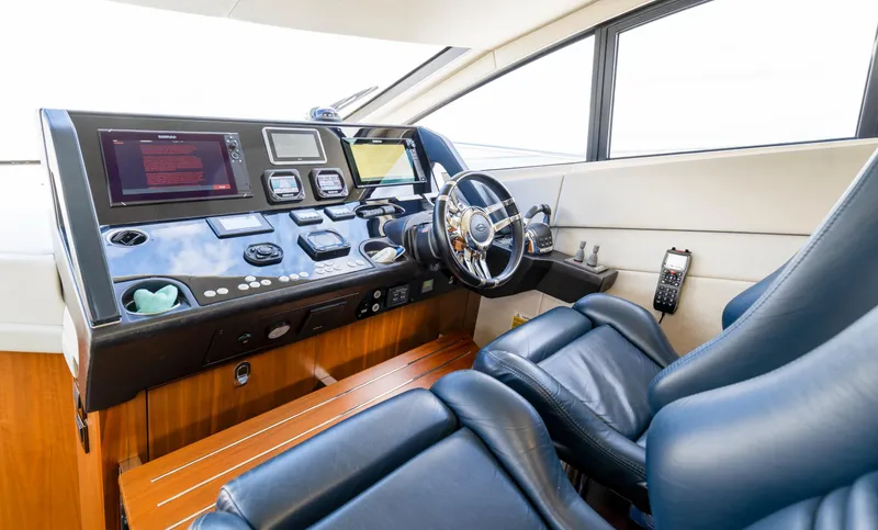 Slide: The Image of Cockpit of 2016 Sunseeker Manhattan 55 yacht with modern controls and leather seating. - 42