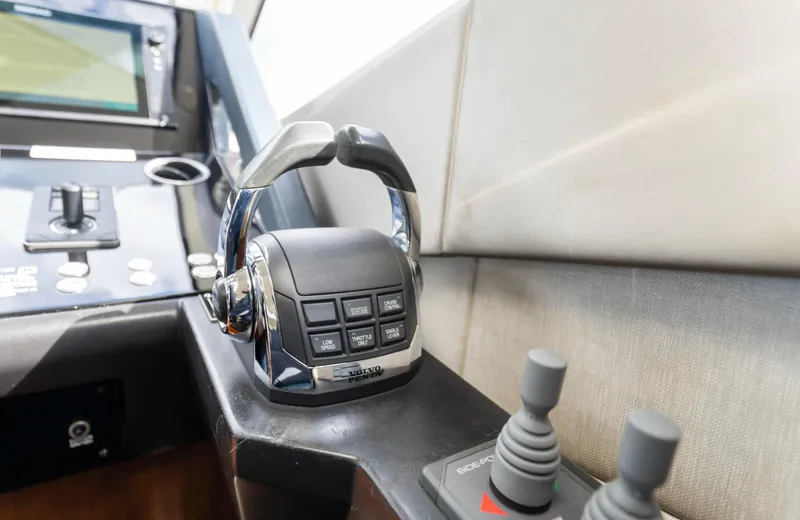 Slide: The Image of Control panel of a 2016 Sunseeker Manhattan 55 yacht, featuring throttle and joystick controls. - 48