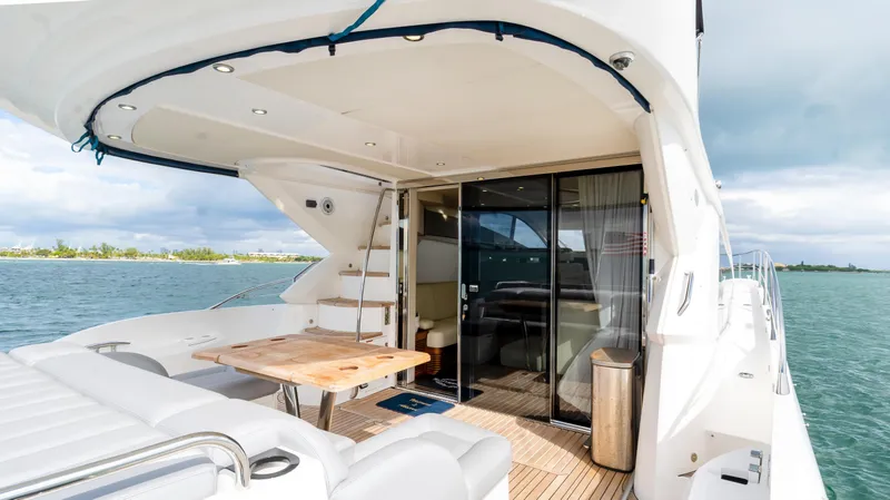 Slide: The Image of Luxurious 2016 Sunseeker Manhattan 55 yacht with elegant outdoor seating and ocean view. - 55