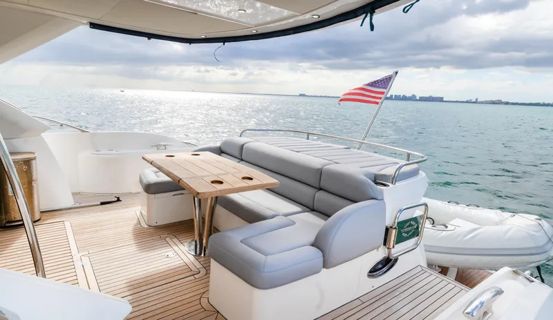 Slide: The Image of Luxurious 2016 Sunseeker Manhattan 55 yacht deck with seating, table, and ocean view. - 57