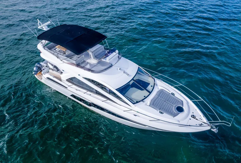 Slide: The Image of 2016 Sunseeker Manhattan 55 yacht cruising on clear blue water. - 6
