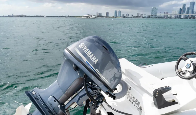 Slide: The Image of Yamaha outboard motor on a Sunseeker Manhattan 55, 2016, with city skyline in background. - 91