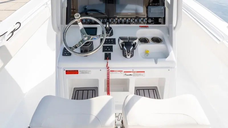 Slide: The Image of 2025 Sea Hunt Ultra 275 SE boat console with steering wheel and controls. - 5