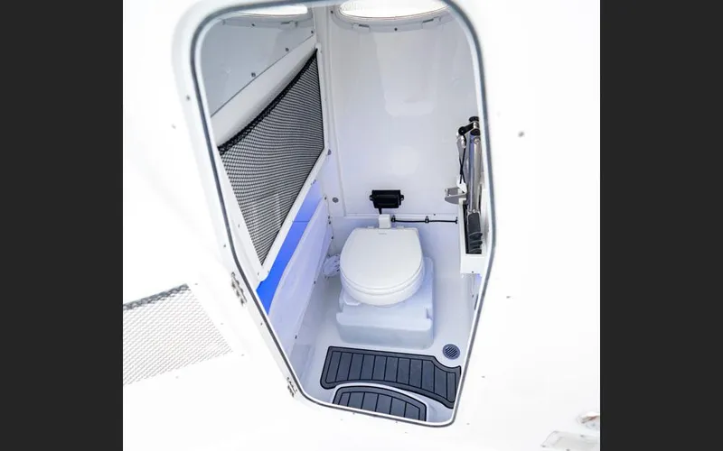 Slide: The Image of 2025 Sea Hunt Ultra 265 SE boat interior with compact marine toilet. - 12
