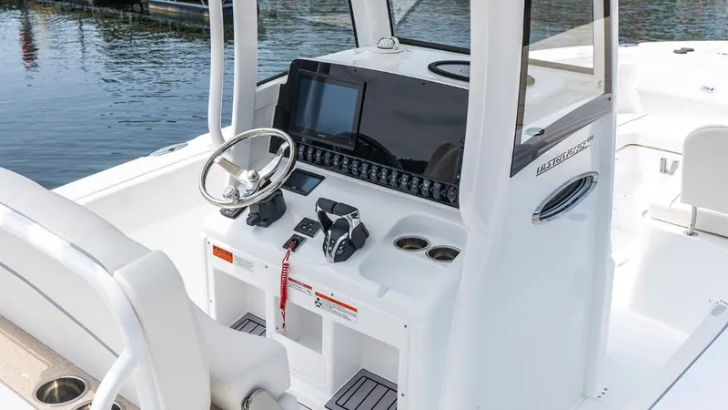 Slide: The Image of 2025 Sea Hunt Ultra 265 SE boat console with steering wheel and controls. - 4