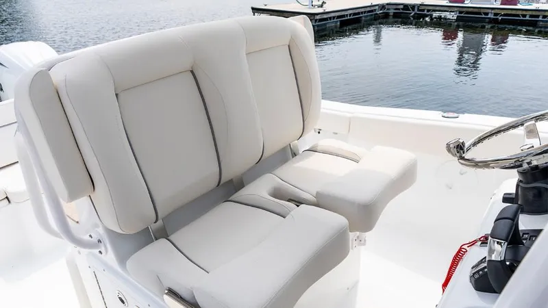Slide: The Image of 2025 Sea Hunt Ultra 265 SE boat interior with plush seating and steering wheel. - 5