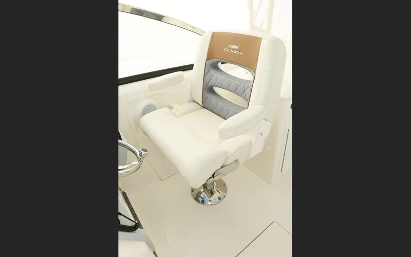 Slide: The Image of Luxury seating on 2025 Cobia 280 DC boat, featuring plush white and gray upholstery. - 12