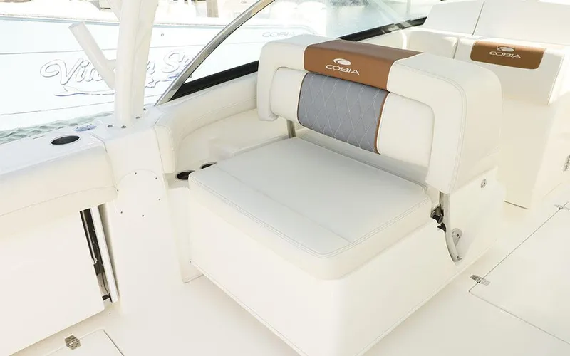 Slide: The Image of 2025 Cobia 280 DC boat interior with luxurious seating and elegant design. - 13