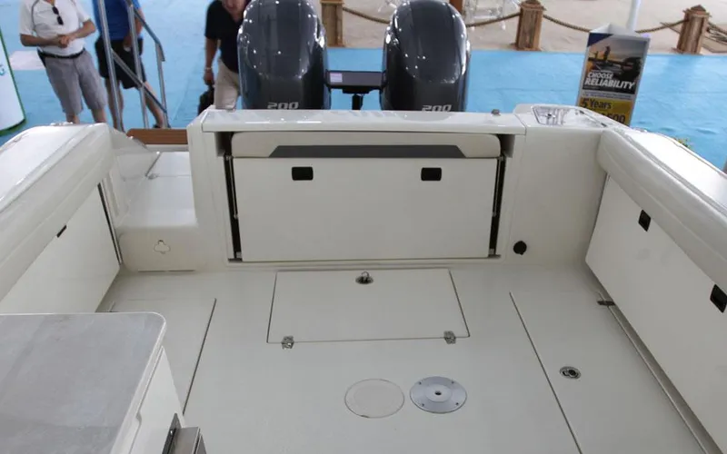 Slide: The Image of 2025 Cobia 280 DC boat interior with dual engines and seating area. - 16