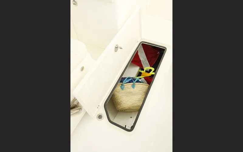 Slide: The Image of Storage compartment on 2025 Cobia 280 DC boat with diving gear and bag. - 25