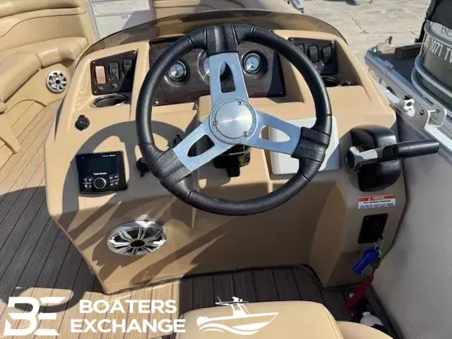 Slide: The Image of 2017 Bennington 21SLX boat steering console with controls and gauges, Boaters Exchange logo visible. - 6
