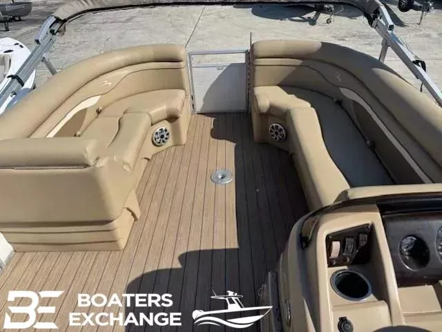 Slide: The Image of 2017 Bennington 21SLX pontoon boat interior with tan seating and wood-style flooring. - 7